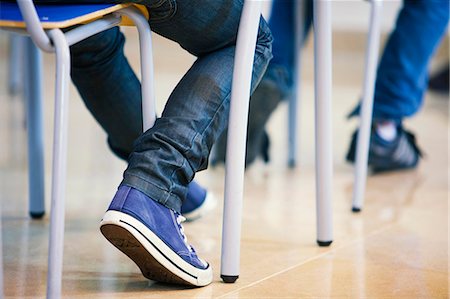 Students sitting at desk in class, low section Stock Photo - Premium Royalty-Free, Code: 649-08894808