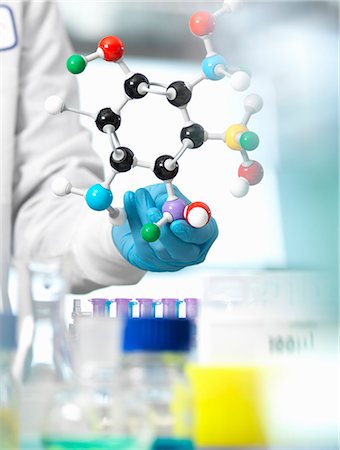 Researcher using a molecular model to understand a chemical formula in a laboratory Stock Photo - Premium Royalty-Free, Code: 649-08894955