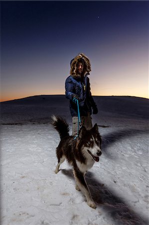 simsearch:400-05724021,k - Mature man walking dog in snow at night Stock Photo - Premium Royalty-Free, Code: 649-08900394