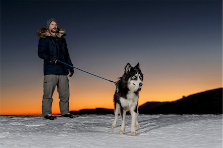simsearch:400-05724021,k - Mature man standing with dog in snow at night Stock Photo - Premium Royalty-Free, Code: 649-08900397