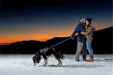 simsearch:400-05724021,k - Romantic couple with dog in snow at night Stock Photo - Premium Royalty-Free, Code: 649-08900398