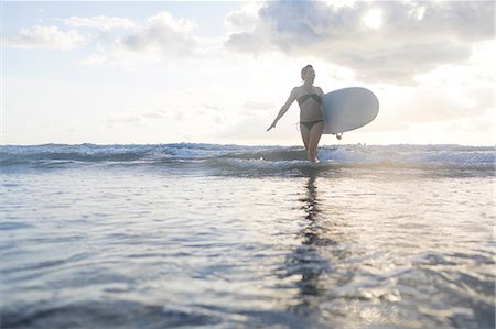 simsearch:649-08900720,k - Woman carrying surfboard in sea, Nosara, Guanacaste Province, Costa Rica Stock Photo - Premium Royalty-Free, Code: 649-08900715