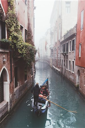 Elevated view of gondolier on misty canal, Venice, Italy Stock Photo - Premium Royalty-Free, Code: 649-08900870
