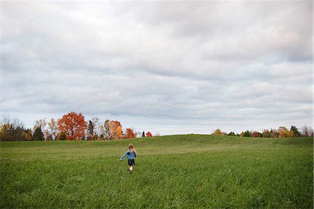 running away scared - Young girl running in open field, Lakefield, Ontario, Canada Stock Photo - Premium Royalty-Free, Code: 649-08900928