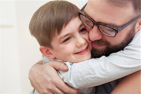 Mid adult man and son hugging each other Stock Photo - Premium Royalty-Free, Code: 649-08901518