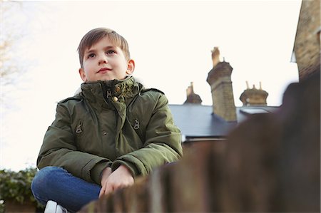 simsearch:649-09078617,k - Portrait of boy sitting looking out from wall Stock Photo - Premium Royalty-Free, Code: 649-08901562