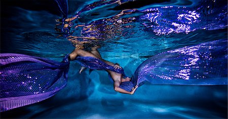 Underwater view of poised woman with wrapped in flowing purple textiles Photographie de stock - Premium Libres de Droits, Code: 649-08902251
