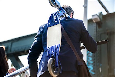 scooter rear view - Businessman carrying scooter, Hungerford Bridge, London, UK Stock Photo - Premium Royalty-Free, Code: 649-08924120