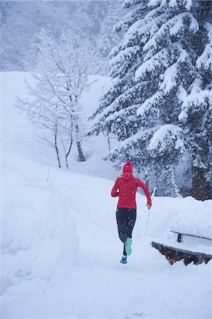 simsearch:649-07437947,k - Rear view of female runner running on track in deep snow, Gstaad, Switzerland Stock Photo - Premium Royalty-Free, Code: 649-08924187