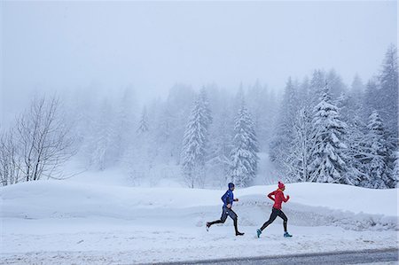 simsearch:649-08924209,k - Distant view of female and male runners running in deep snow, Gstaad, Switzerland Stock Photo - Premium Royalty-Free, Code: 649-08924197