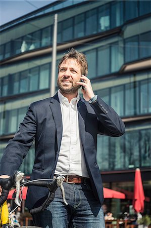simsearch:859-06710917,k - Businessman with bicycle making smartphone call in city Stock Photo - Premium Royalty-Free, Code: 649-08924219
