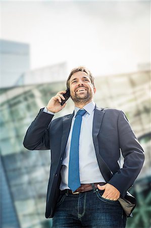 simsearch:859-06710917,k - Happy businessman making smartphone call in city Stock Photo - Premium Royalty-Free, Code: 649-08924227
