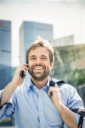 simsearch:859-06710917,k - Portrait of happy businessman making smartphone call in city Stock Photo - Premium Royalty-Free, Code: 649-08924230