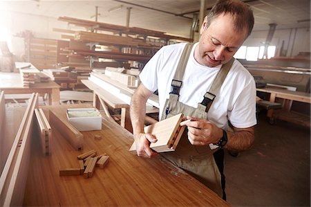 simsearch:649-07710266,k - Male carpenter inserting wooden dowel at workbench Stock Photo - Premium Royalty-Free, Code: 649-08924249
