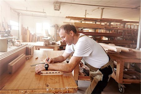 simsearch:6115-07109879,k - Male carpenter marking wood with pencil at workbench Stock Photo - Premium Royalty-Free, Code: 649-08924254