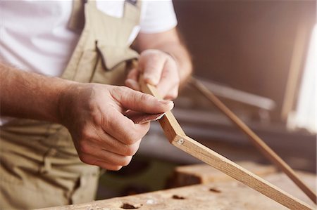 simsearch:649-07710266,k - Hands of male carpenter sanding frame at workbench Stock Photo - Premium Royalty-Free, Code: 649-08924256