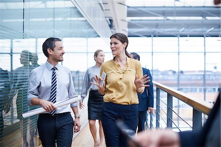 simsearch:649-07520071,k - Businesswoman and men walking and talking on office balcony Stock Photo - Premium Royalty-Free, Code: 649-08924329