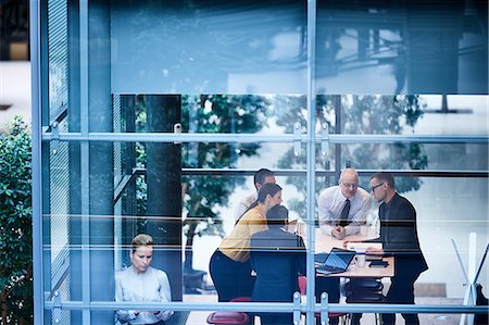 Window view of businesswomen and men having discussion in conference room Stock Photo - Premium Royalty-Free, Code: 649-08924323