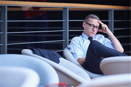simsearch:614-06718128,k - Businessman sitting reading on office balcony Stock Photo - Premium Royalty-Free, Code: 649-08924366
