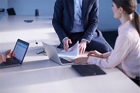 simsearch:649-07238396,k - Businesswoman and men using laptops boardroom table Stock Photo - Premium Royalty-Free, Code: 649-08924437