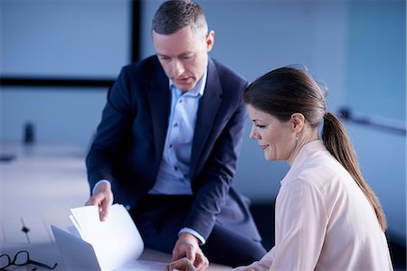 report (written account) - Cropped shot of businessman and woman reading paperwork at office desk Stock Photo - Premium Royalty-Free, Code: 649-08924432