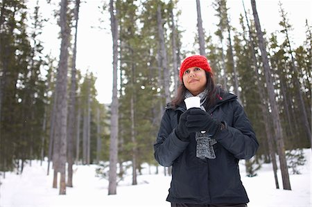 simsearch:649-08924209,k - Woman by snow covered forest holding hot drink, Banff, Canada Stock Photo - Premium Royalty-Free, Code: 649-08924632