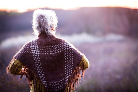 simsearch:649-08924209,k - Rear view of mature woman watching sunset over rural landscape Stock Photo - Premium Royalty-Free, Code: 649-08923224