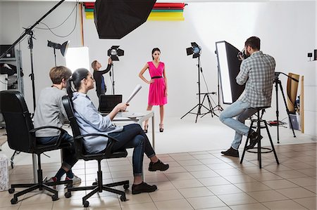 Photography team and model in white backdrop photography studio shoot Stock Photo - Premium Royalty-Free, Code: 649-08923861