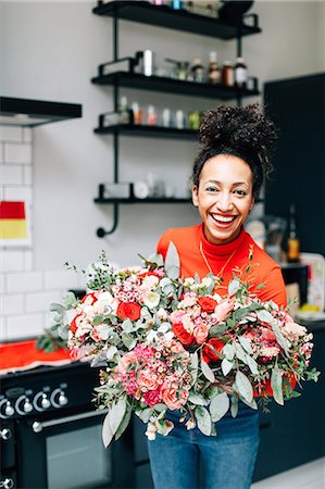 small business florist - Portrait of mid adult female florist holding flower bouquet in florists workshop Stock Photo - Premium Royalty-Free, Code: 649-08923974