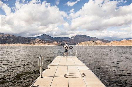 simsearch:649-08924209,k - Rear view of man looking out from windy pier on Lake Isabella, California, USA Stock Photo - Premium Royalty-Free, Code: 649-08949365