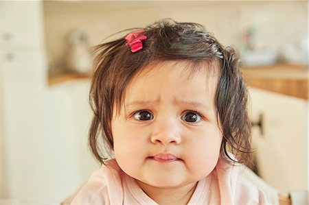 Portrait of cute baby girl pulling a face Stock Photo - Premium Royalty-Free, Code: 649-08949470