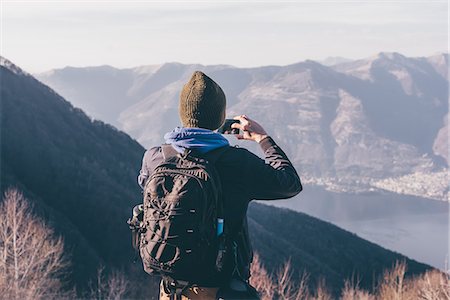 simsearch:649-08924209,k - Rear view of male hiker photographing lake and mountains, Monte San Primo, Italy Stock Photo - Premium Royalty-Free, Code: 649-08949538