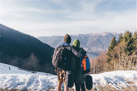 Rear view of hiking couple looking out over lake and mountains, Monte San Primo, Italy Stock Photo - Premium Royalty-Free, Code: 649-08949539