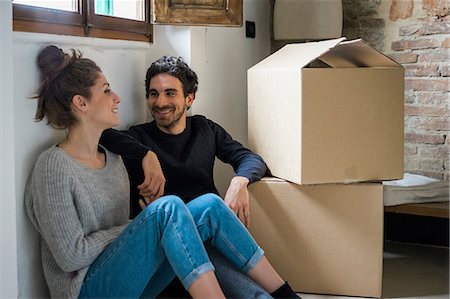 Young couple sitting on floor by cardboard boxes Stock Photo - Premium Royalty-Free, Code: 649-08949589