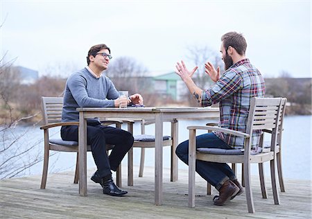 plaid shirt - Two male designers having discussion on waterfront outside design studio Stock Photo - Premium Royalty-Free, Code: 649-08949788