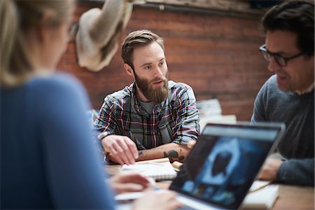 plaid shirt - Design team having brainstorming meeting at design studio desk Stock Photo - Premium Royalty-Free, Code: 649-08949811