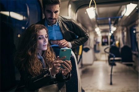 simsearch:862-06541761,k - Couple using mobile phone in train, Florence, Italy Stock Photo - Premium Royalty-Free, Code: 649-08950150