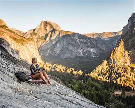 simsearch:614-07486939,k - Woman on rock looking out at valley forest, Yosemite National Park, California, USA Stock Photo - Premium Royalty-Free, Code: 649-08950376