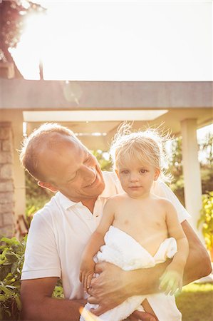 simsearch:649-07437107,k - Portrait of father holding young son, outdoors, smiling Stock Photo - Premium Royalty-Free, Code: 649-08950524