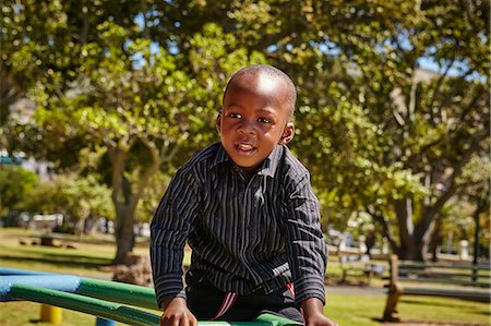 Boy on climbing frame in playground Stock Photo - Premium Royalty-Free, Code: 649-08950608
