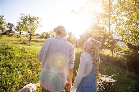 simsearch:400-05724021,k - Rear view of young couple walking dog in sunlit rural field, Majorca, Spain Stock Photo - Premium Royalty-Free, Code: 649-08951029