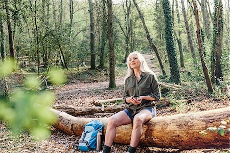 simsearch:649-08086253,k - Mature female backpacker sitting on log in forest, Scandicci, Tuscany, Italy Stock Photo - Premium Royalty-Free, Code: 649-08951147