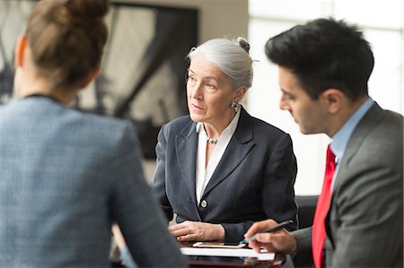 simsearch:655-03458001,k - Businessman discussing with female colleagues in boardroom meeting Stock Photo - Premium Royalty-Free, Code: 649-08968786