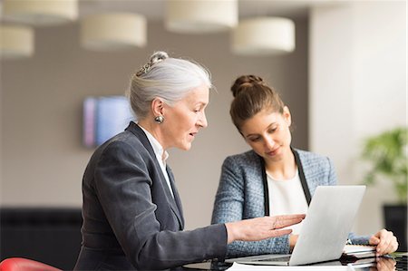 simsearch:649-07238396,k - Businesswoman explaining to female colleague in boardroom meeting Stock Photo - Premium Royalty-Free, Code: 649-08968789