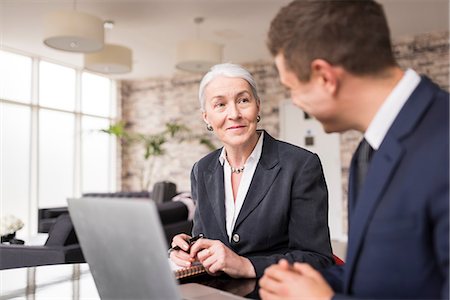 simsearch:649-07238396,k - Businesswoman meeting male colleague in boardroom Stock Photo - Premium Royalty-Free, Code: 649-08968791