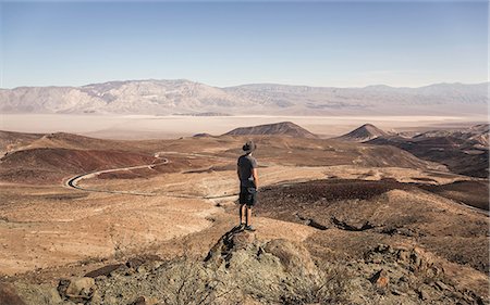 Man on rock looking out over Death Valley National Park, California, USA Stock Photo - Premium Royalty-Free, Code: 649-08968965