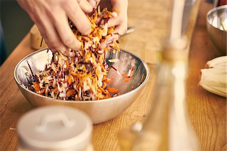 Cropped view of chef tossing salad with hands Stock Photo - Premium Royalty-Free, Code: 649-08969436