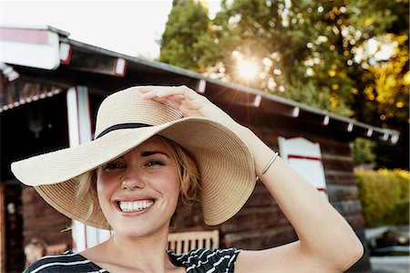 simsearch:649-05819818,k - Woman holding onto wide-brimmed hat Stock Photo - Premium Royalty-Free, Code: 649-08988403