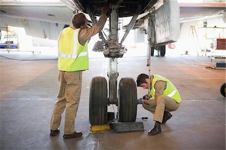 simsearch:649-07238739,k - Aircraft workers checking wheels Stock Photo - Premium Royalty-Free, Code: 649-09002577