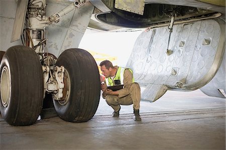 simsearch:649-07238739,k - Aircraft worker checking airplane Stock Photo - Premium Royalty-Free, Code: 649-09002588